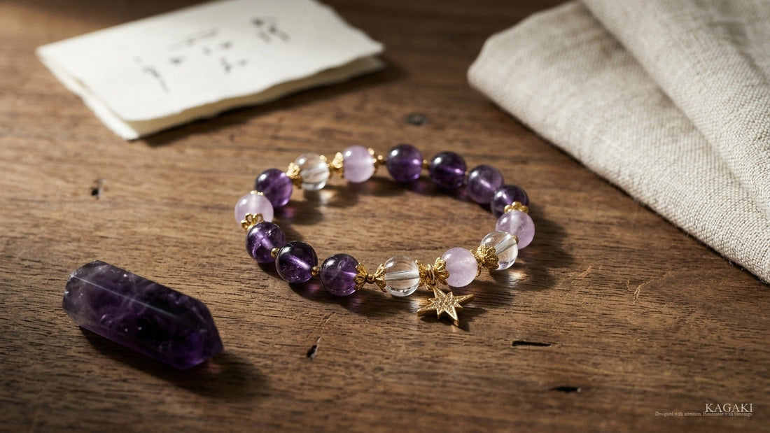 KAGAKI Star amethyst and clear quartz bracelet at gentle rest on aged walnut beside a polished amethyst point and a folded cream linen in soft afternoon daylight, shown as an editorial hero image for a respectful studio guide to crystals for anxiety.