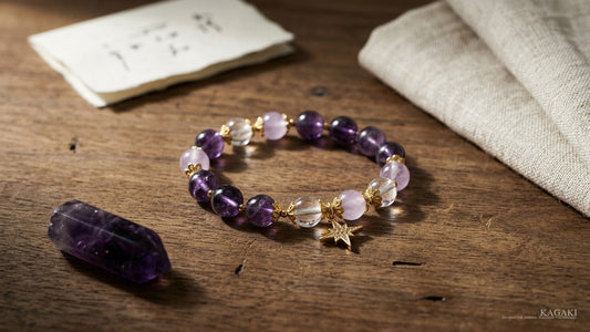 KAGAKI Star amethyst and clear quartz bracelet at gentle rest on aged walnut beside a polished amethyst point and a folded cream linen in soft afternoon daylight, shown as an editorial hero image for a respectful studio guide to crystals for anxiety.