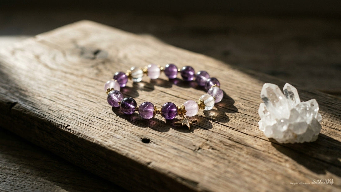 KAGAKI Star amethyst and clear quartz bracelet at rest on aged walnut beside a small raw clear quartz cluster in soft afternoon daylight, shown as an editorial hero image for a respectful studio guide to feng shui crystals.
