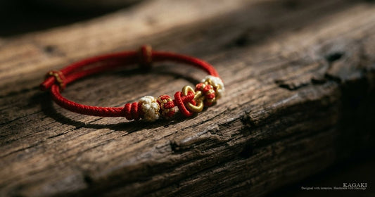 KAGAKI Tibetan knot-macro editorial — close detail of red string friendship knot at front-center of cord