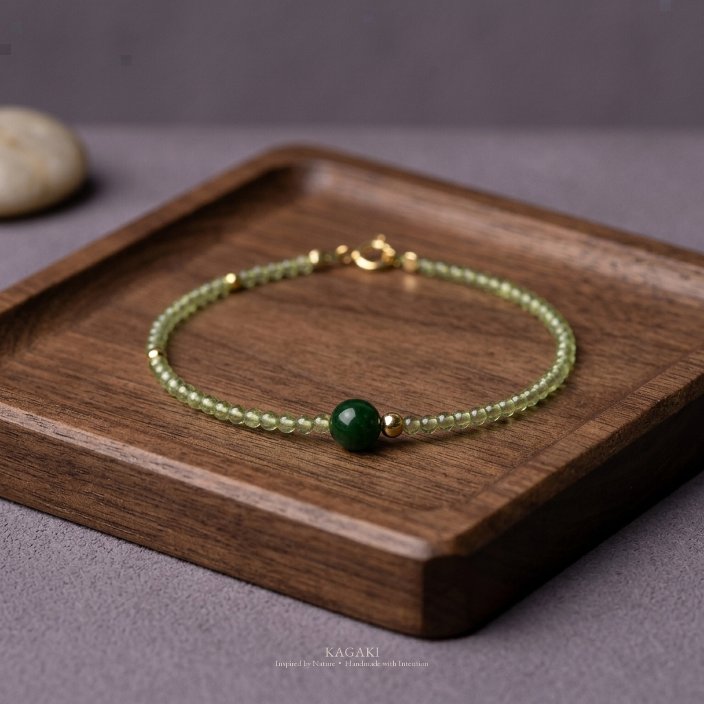KAGAKI green jade crystal bracelet with dark green jade focal bead and gold spacers — zen refined still-life editorial view.