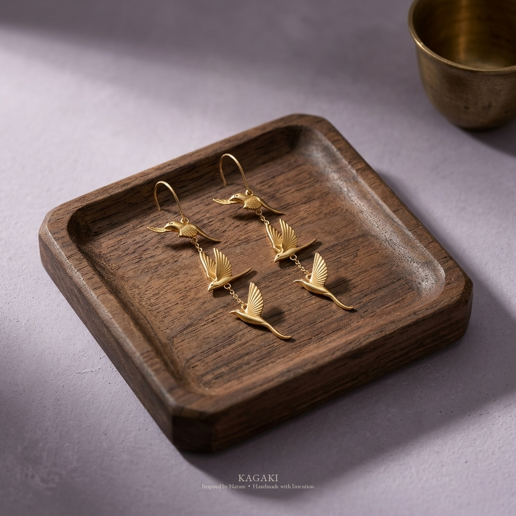 KAGAKI gold flying-swallow handmade dangle earrings — zen refined still-life editorial view.