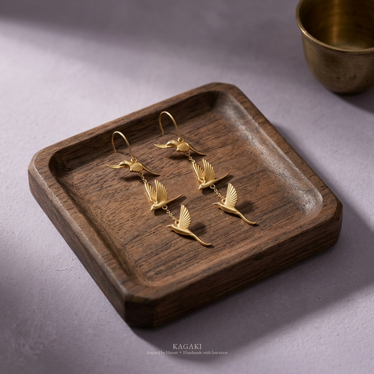 KAGAKI gold flying-swallow handmade dangle earrings — zen refined still-life editorial view.