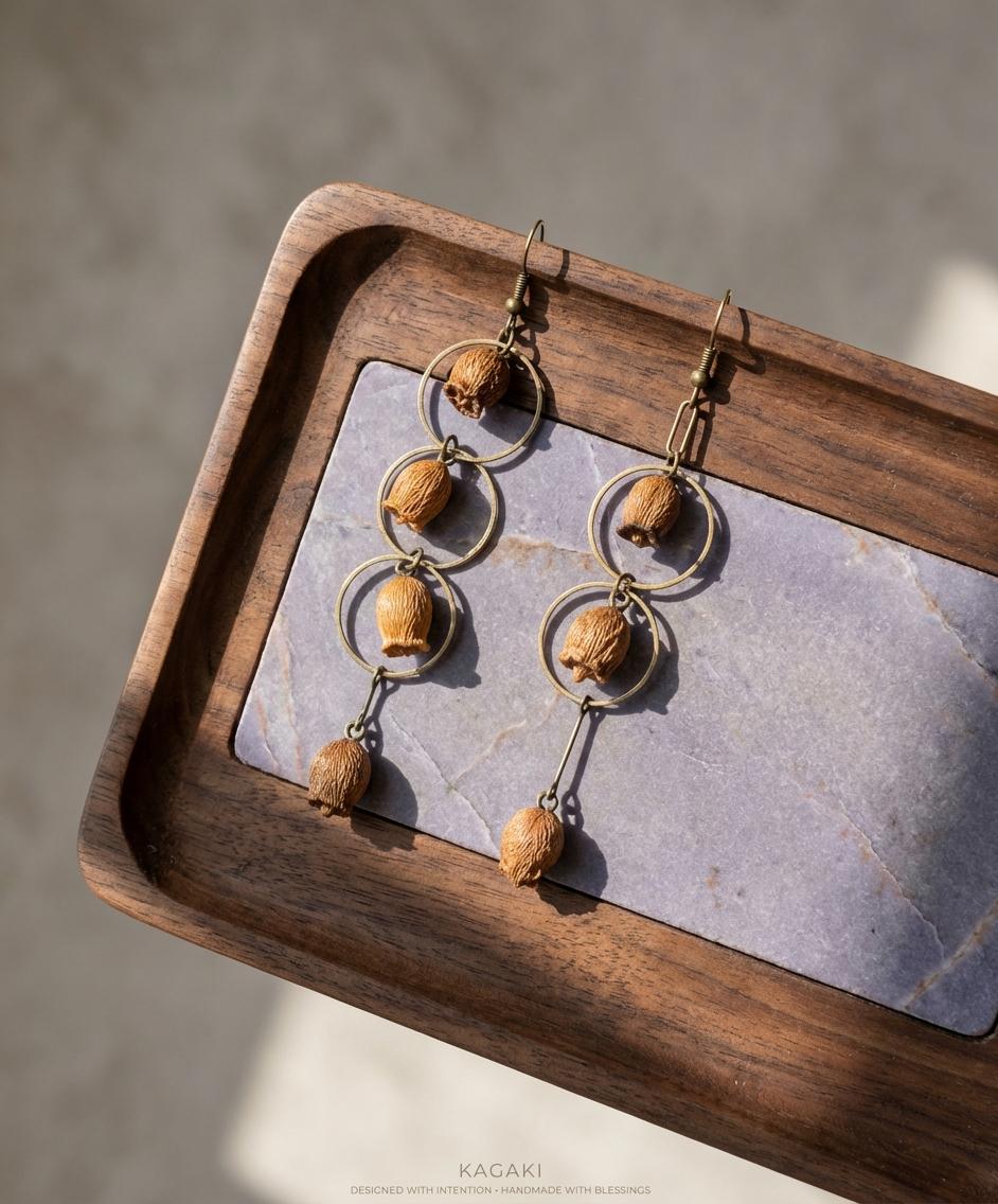 KAGAKI botanical dried fruit shell earrings in natural earth tones, on ear, for daily wear and gifting