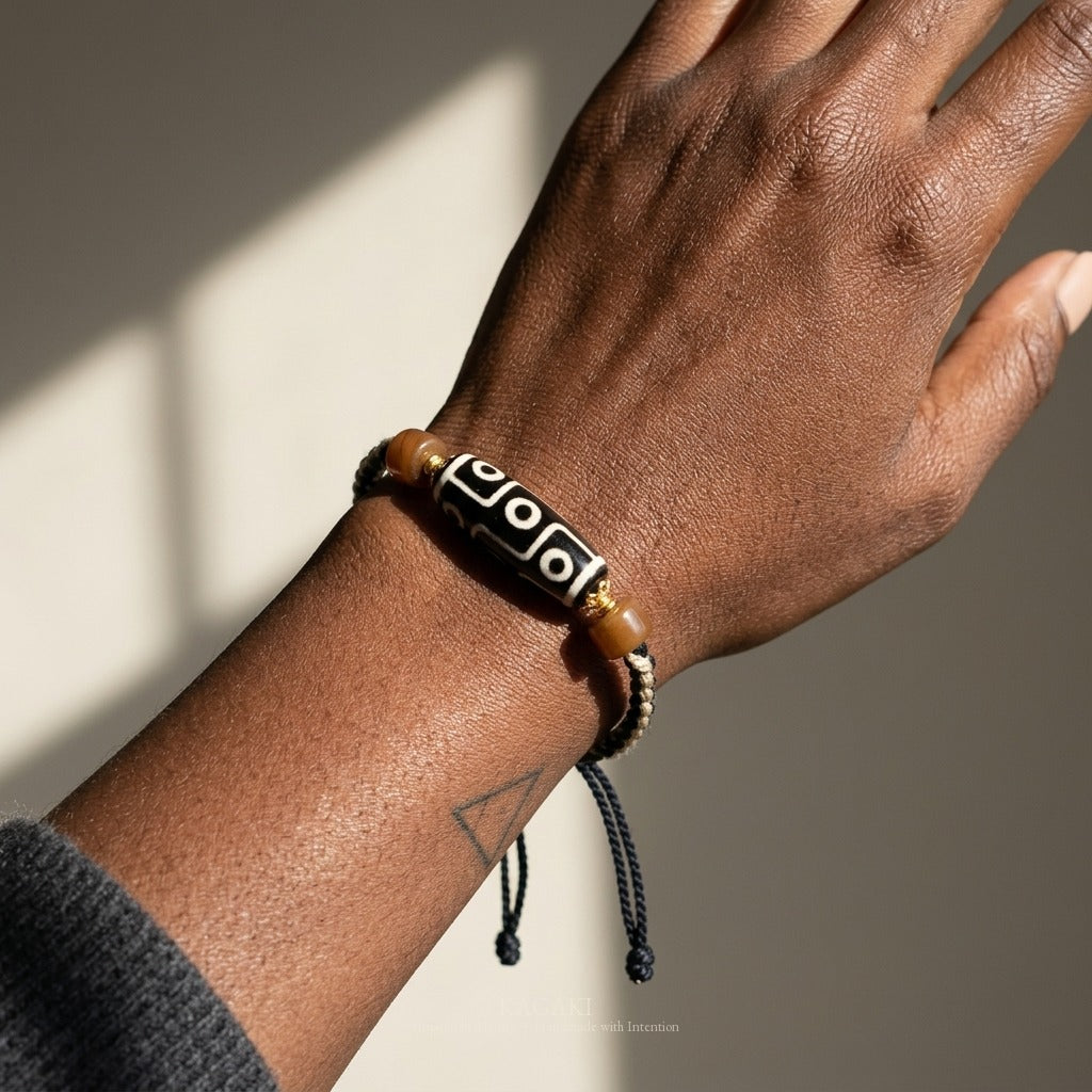 KAGAKI handmade Tibetan-inspired nine-eye Dzi-style cord bracelet — Vigil – 守 — on-wrist macro detail.
