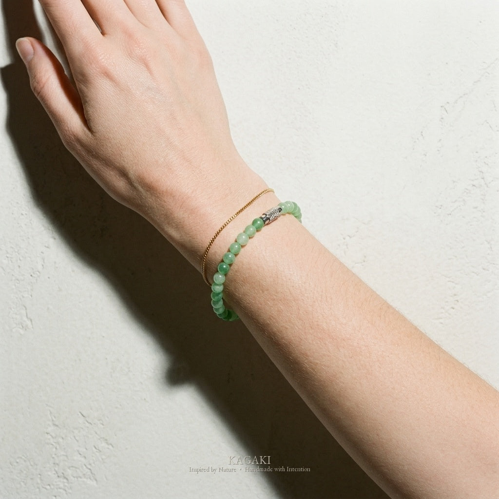 Green jade bracelet on the wrist — soft daylight