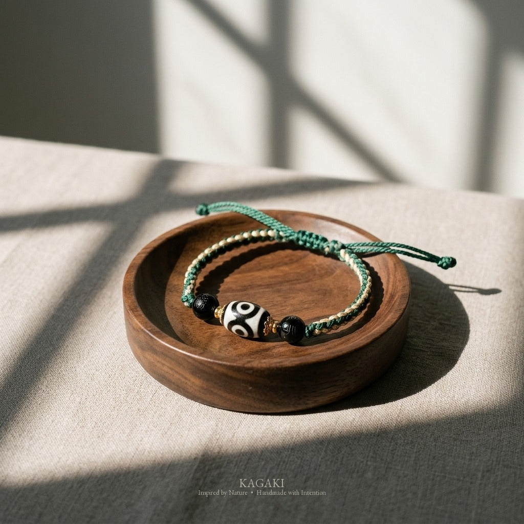 KAGAKI handmade Tibetan-inspired three-eye Dzi-style cord bracelet — Triad – 三 — styled-scene (1/11)
