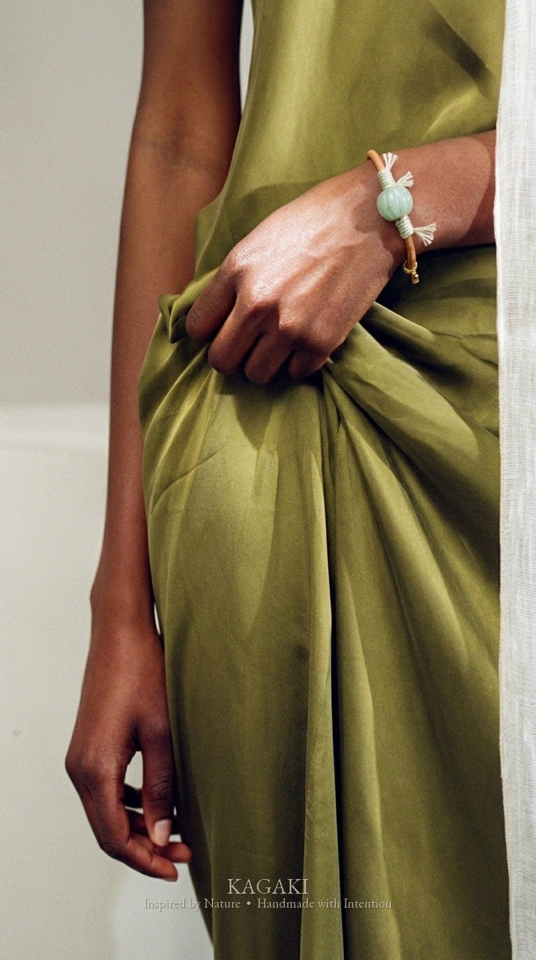 KAGAKI Canyon smooth pale green Jadeite barrel bead leather cord bracelet, green tassel wraps, gold-thread slider, worn on wr