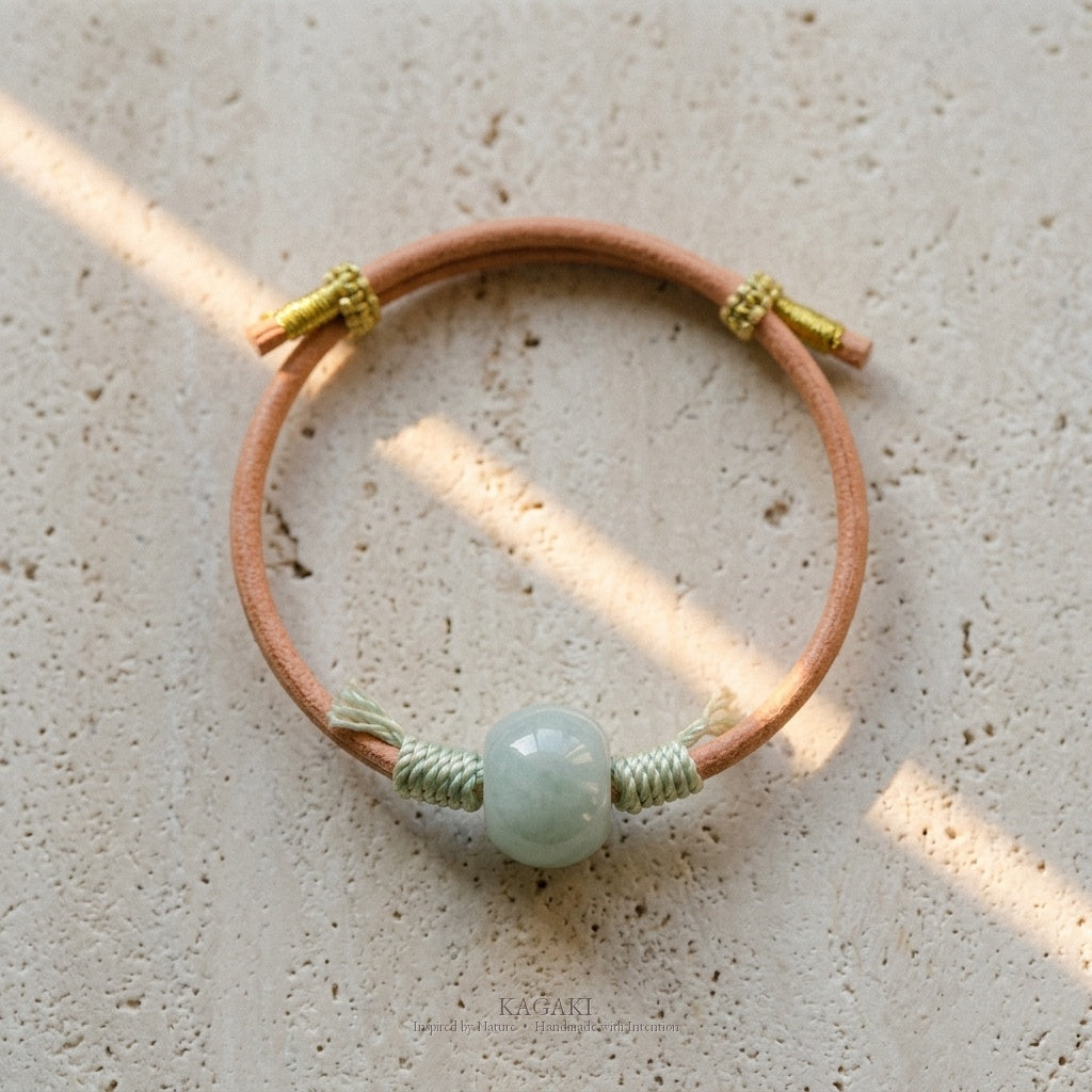KAGAKI Canyon smooth pale green Jadeite barrel bead leather cord bracelet, green tassel wraps, gold-thread slider, studio vie