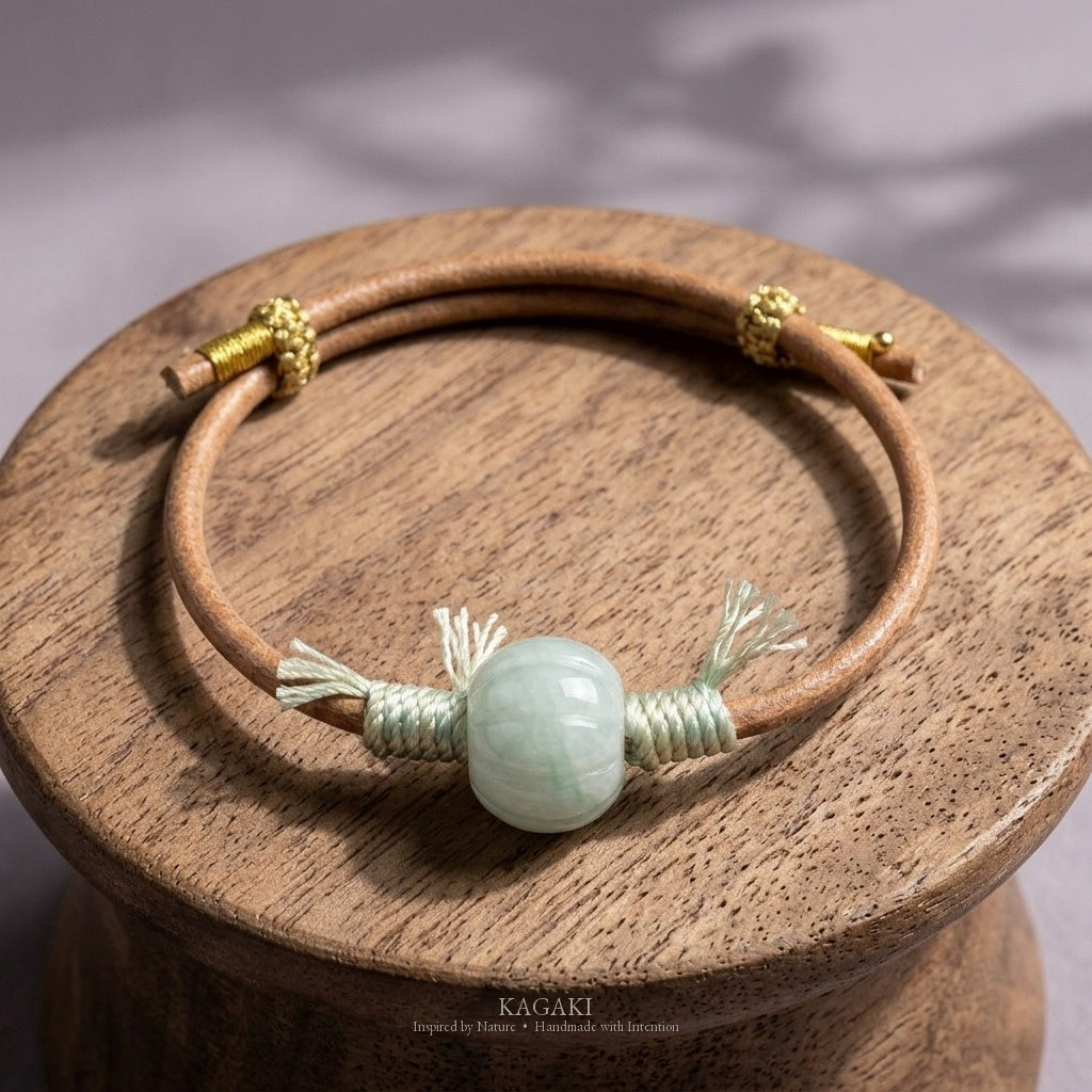 KAGAKI Canyon smooth pale green Jadeite barrel bead leather cord bracelet, green tassel wraps, gold-thread slider, studio vie
