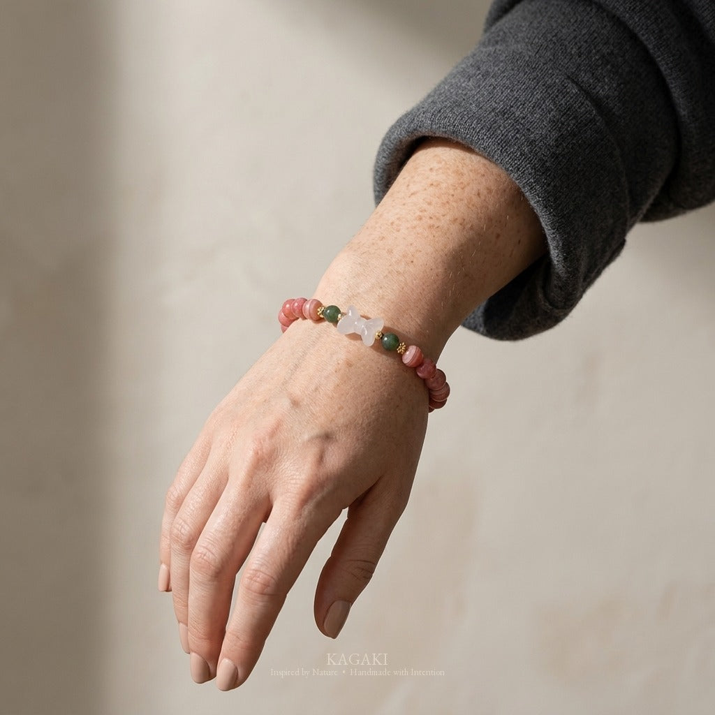 KAGAKI handmade crystal bracelet pink stone beaded bow stretch bracelet — pink + white + gold, luxury jewelry editorial wearing shot.