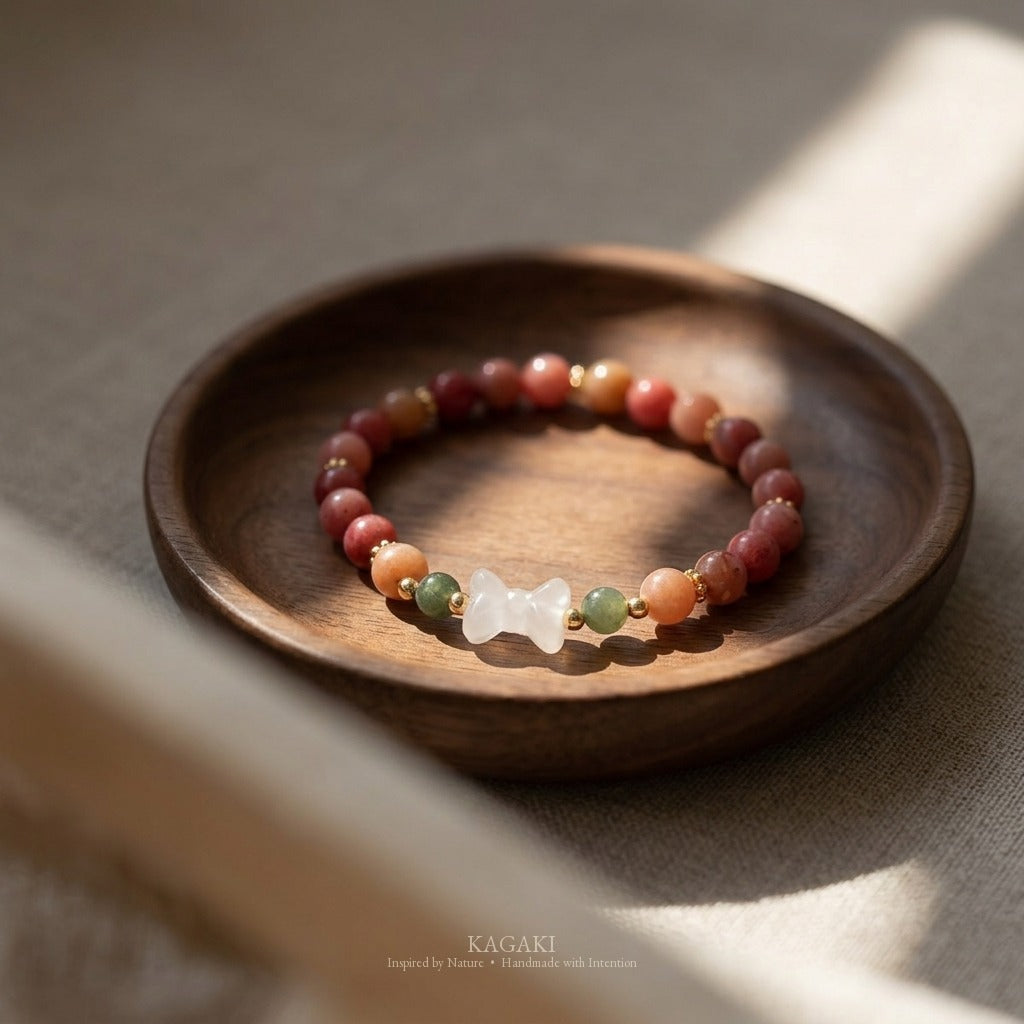 KAGAKI handmade crystal bracelet pink stone beaded bow stretch bracelet — pink + white + gold, editorial styled scene.