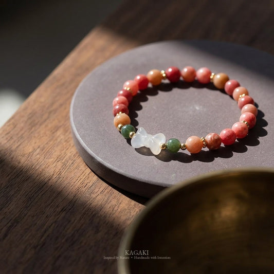 KAGAKI handmade crystal bracelet pink stone beaded bow stretch bracelet — pink + white + gold, editorial styled scene.