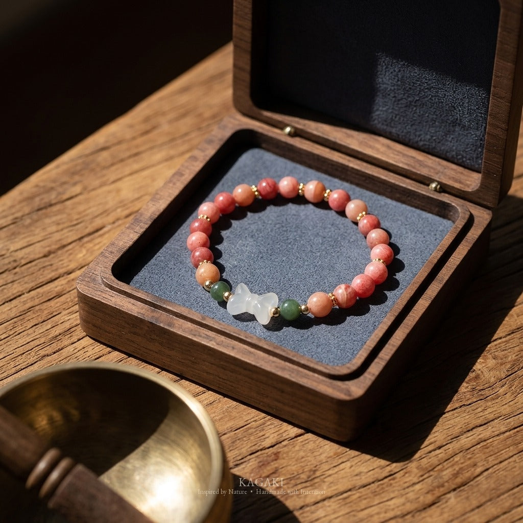 KAGAKI handmade crystal bracelet pink stone beaded bow stretch bracelet — pink + white + gold, editorial styled scene.