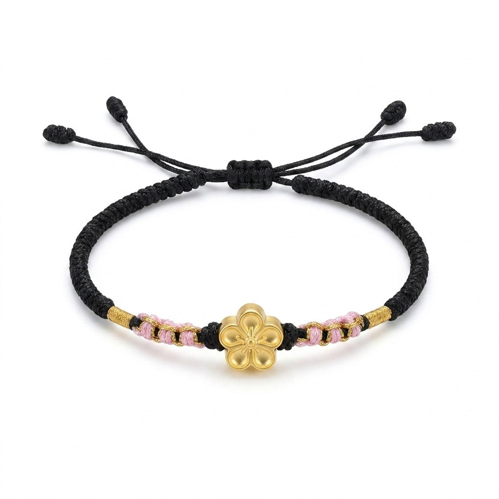 KAGAKI handmade cord bracelet sakura plum blossom cord bracelet (ink & petal) — black / green / red with gold accent, main catalog image on white.