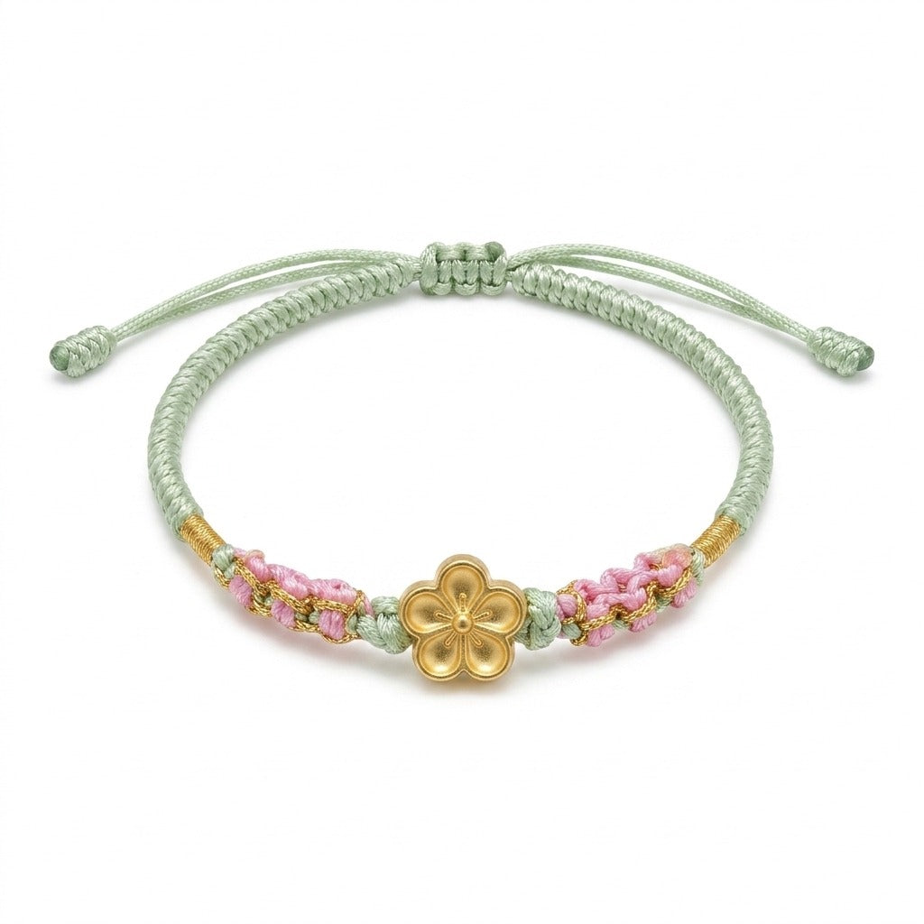 KAGAKI handmade cord bracelet sakura plum blossom cord bracelet (moss & petal) — black / green / red with gold accent, main catalog image on white.