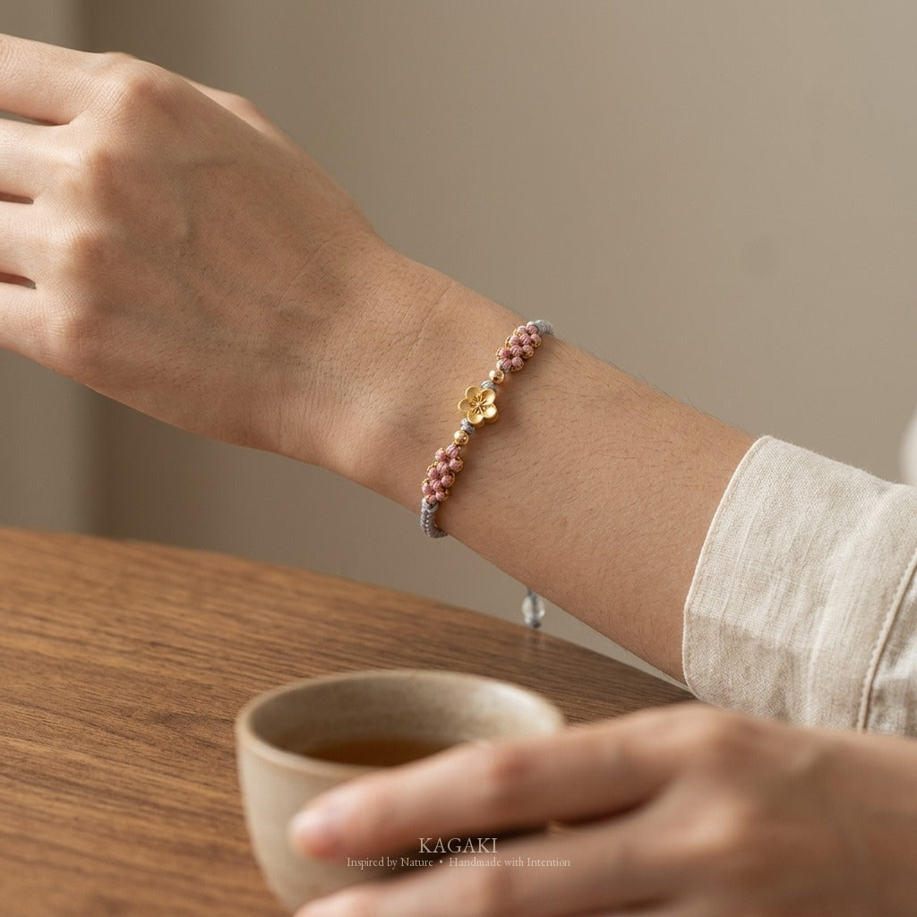 KAGAKI handmade cord bracelet sakura pastel cord bracelet (mist & petal) — mist blue or dawn pink with gold accent, wrist wearing image.