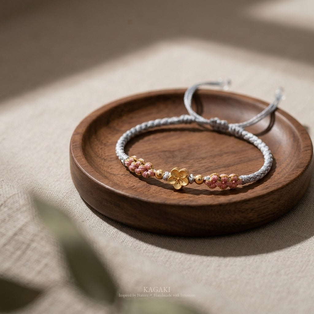 KAGAKI handmade cord bracelet sakura pastel cord bracelet (mist & petal) — mist blue or dawn pink with gold accent, editorial styled scene.