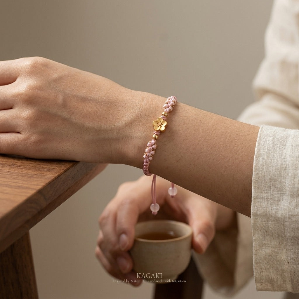 KAGAKI handmade cord bracelet sakura pastel cord bracelet (dawn & petal) — mist blue or dawn pink with gold accent, wrist wearing image.