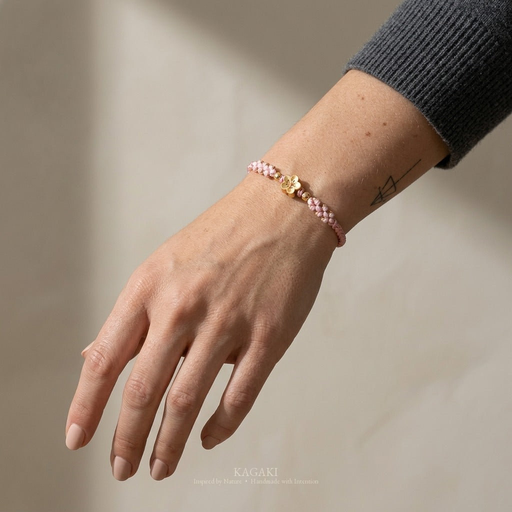 KAGAKI handmade cord bracelet sakura pastel cord bracelet (dawn & petal) — mist blue or dawn pink with gold accent, luxury jewelry editorial wearing shot.