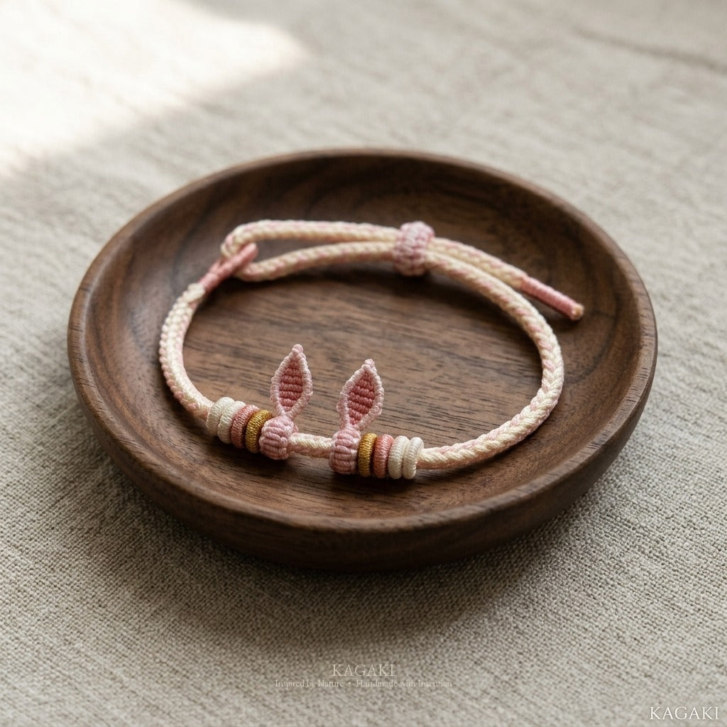 KAGAKI Bunny Knot soft pink bunny ear cord, studio view, handmade cord bracelet gift
