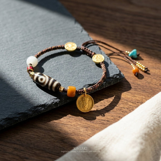 KAGAKI handmade cord bracelet tibetan dzi cord bracelet — brown + black + gold, editorial styled scene.