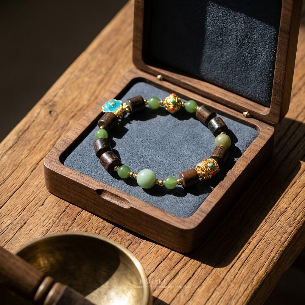 KAGAKI handmade crystal bracelet tibetan jade agarwood beaded bracelet — green + dark brown + gold, editorial styled scene.