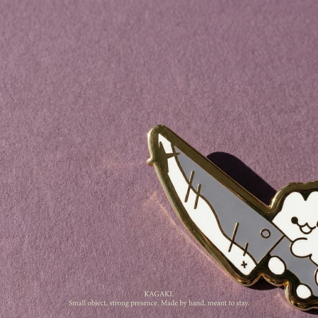 KAGAKI cat knife enamel pin in soft pastel with gold outline, alternate angle, for daily wear and gifting