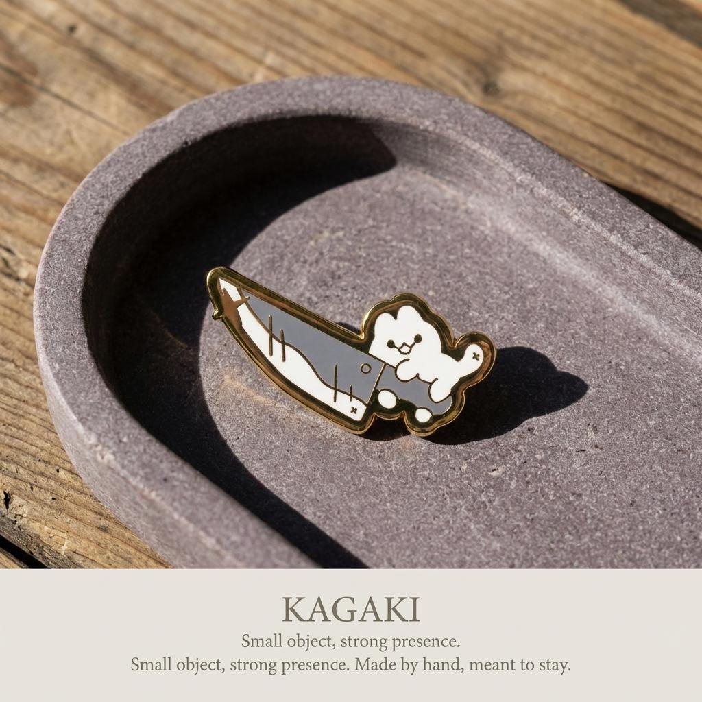 KAGAKI cat knife enamel pin in soft pastel with gold outline, on jacket, for daily wear and gifting