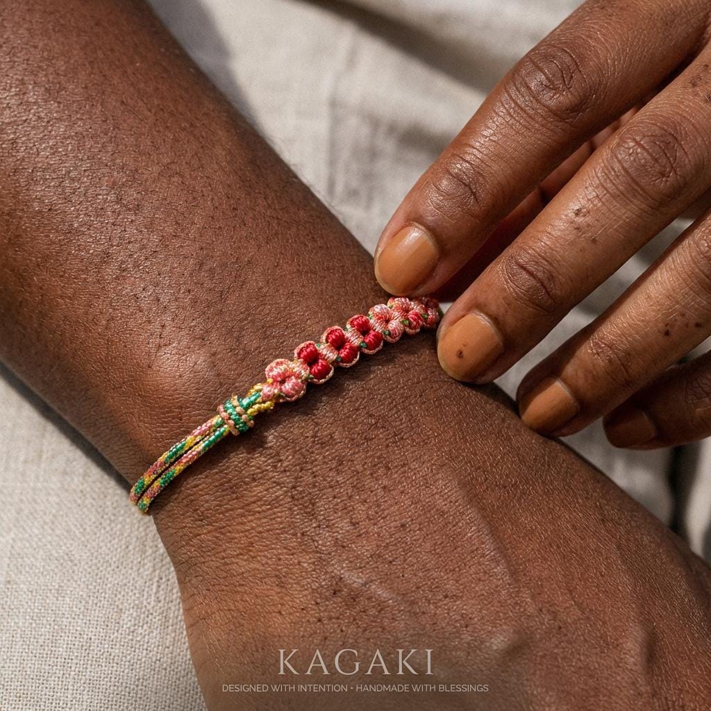 KAGAKI cherry-blossom sakura bracelet in soft pink handwoven cord with floral knot, alternate angle styling view, for renewal and gentle protection