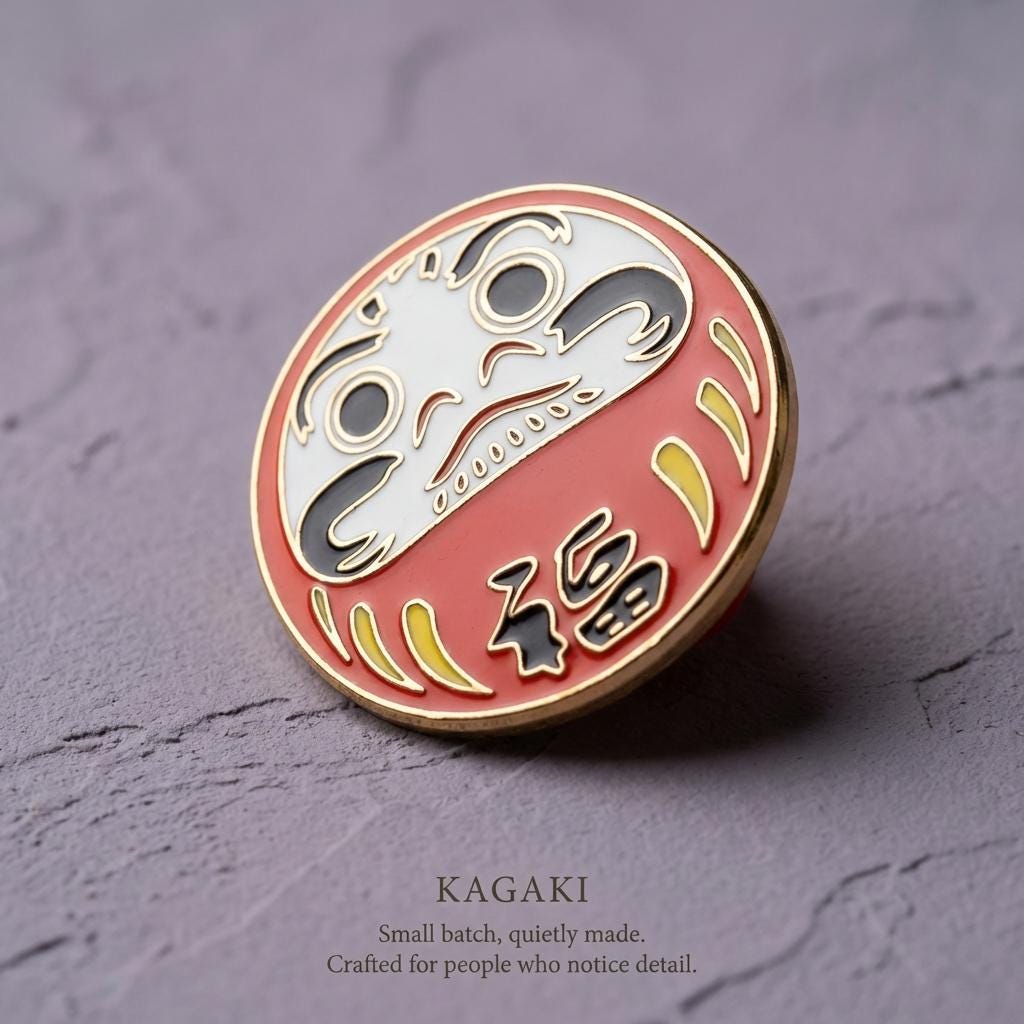 KAGAKI daruma lucky enamel pin in classic Daruma red and gold, alternate angle, for daily wear and gifting