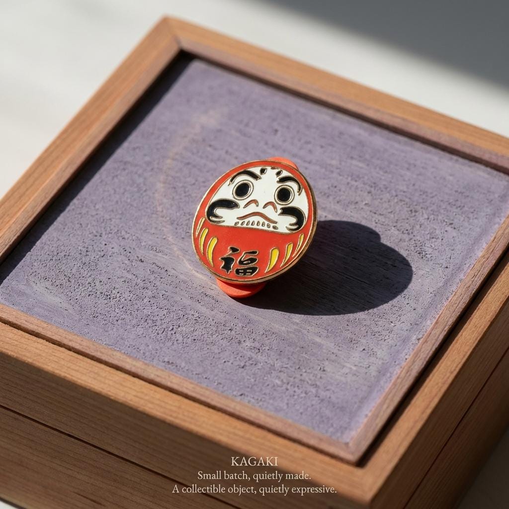 KAGAKI daruma lucky enamel pin in classic Daruma red and gold, on jacket, for daily wear and gifting