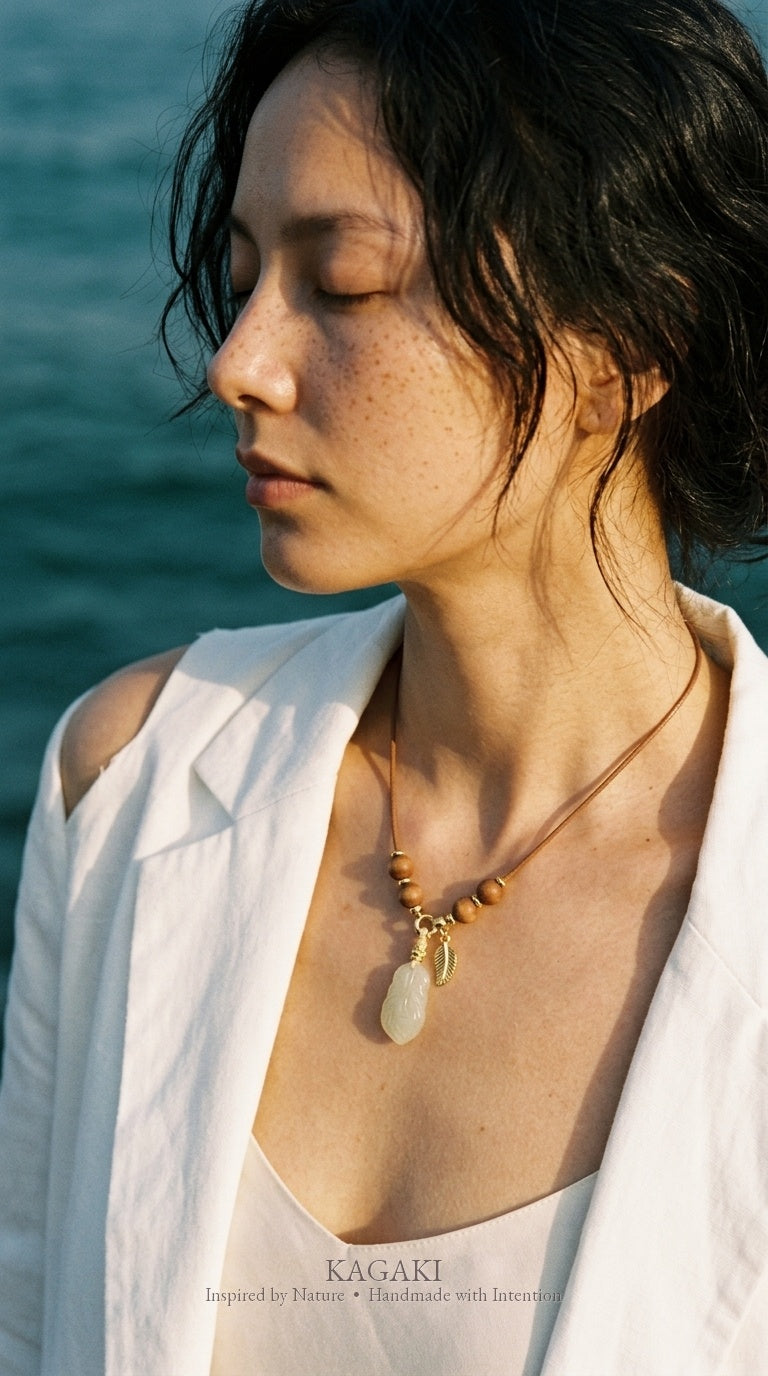 KAGAKI Plume green jade feather pendant sandalwood cord necklace, worn view, handmade feather necklace