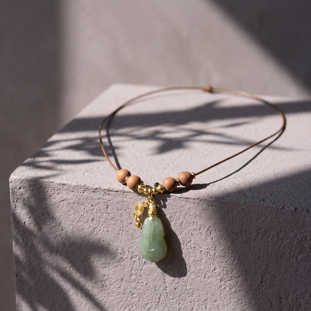 KAGAKI Plume green jade feather pendant sandalwood cord necklace, studio styled view, handmade feather necklace
