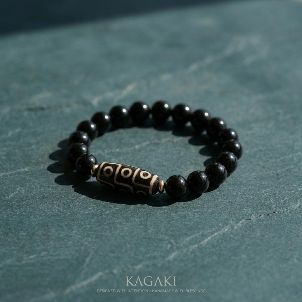 KAGAKI obsidian dzi bead bracelet in deep black obsidian, on wrist, for meditation and daily intention
