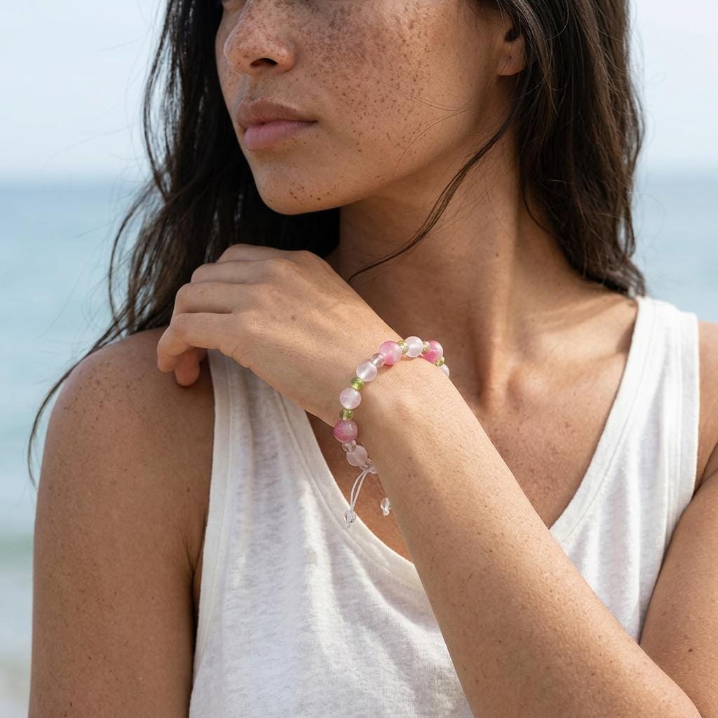 KAGAKI rose quartz beaded bracelet shown on hand as a scale reference for soft pink crystal bracelet sizing