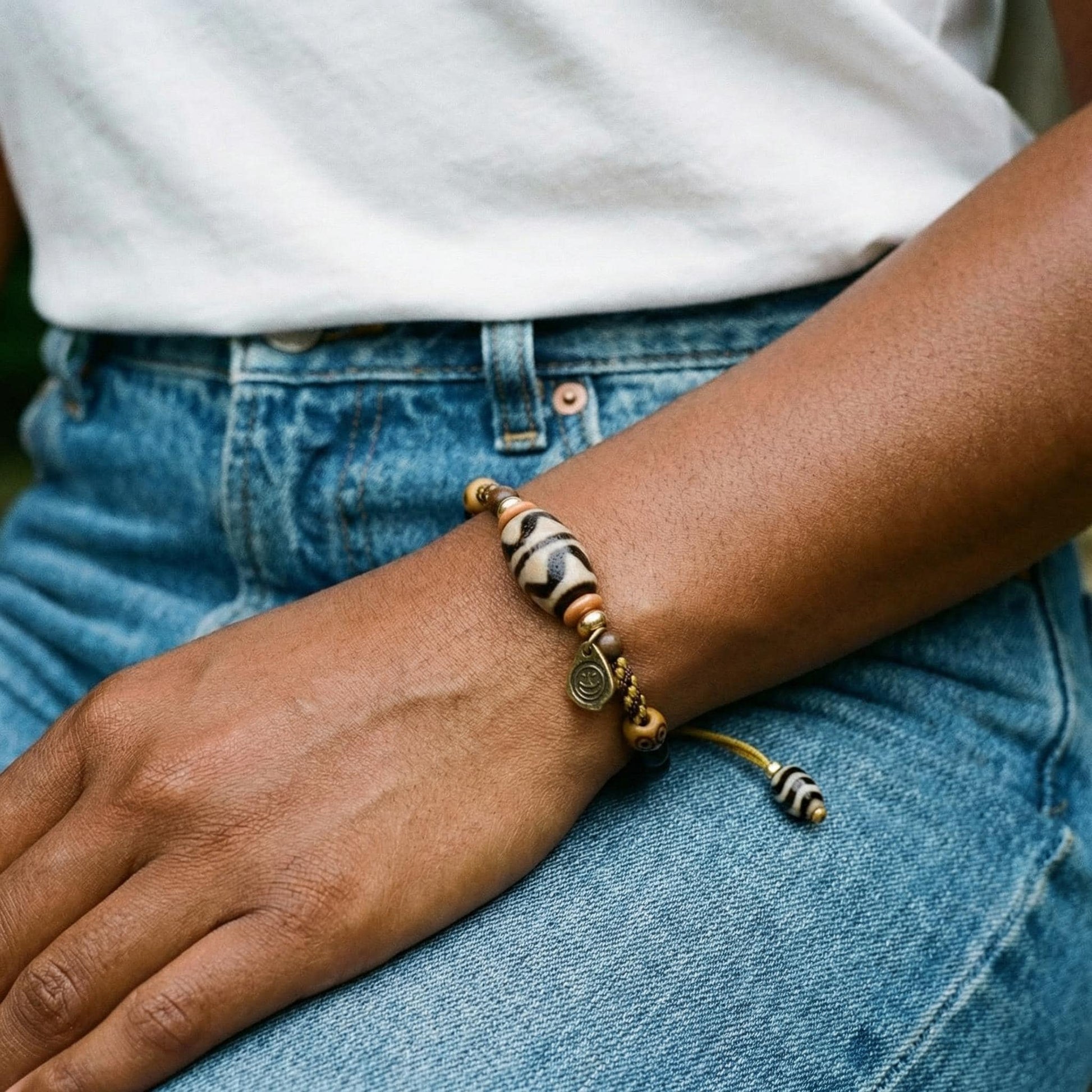 KAGAKI tibetan ceramic amulet cord bracelet in black with ceramic accent, on wrist, for meditation and daily intention