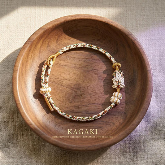 KAGAKI Tibetan meditation protection bracelet in deep black handwoven cord with gold-tone accent, main product view, for grounding and daily intention