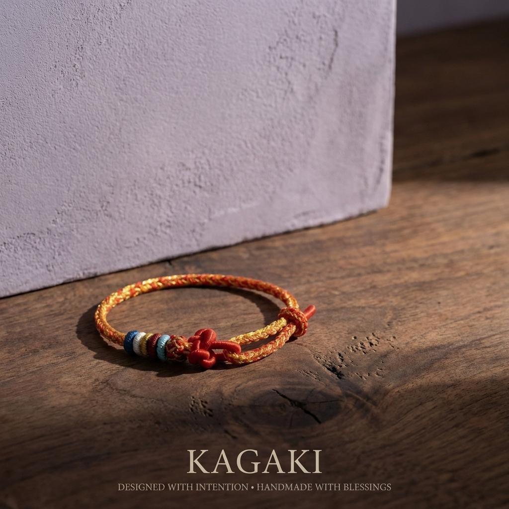 KAGAKI Tibetan red string cord bracelet on natural stone surface for an editorial product view